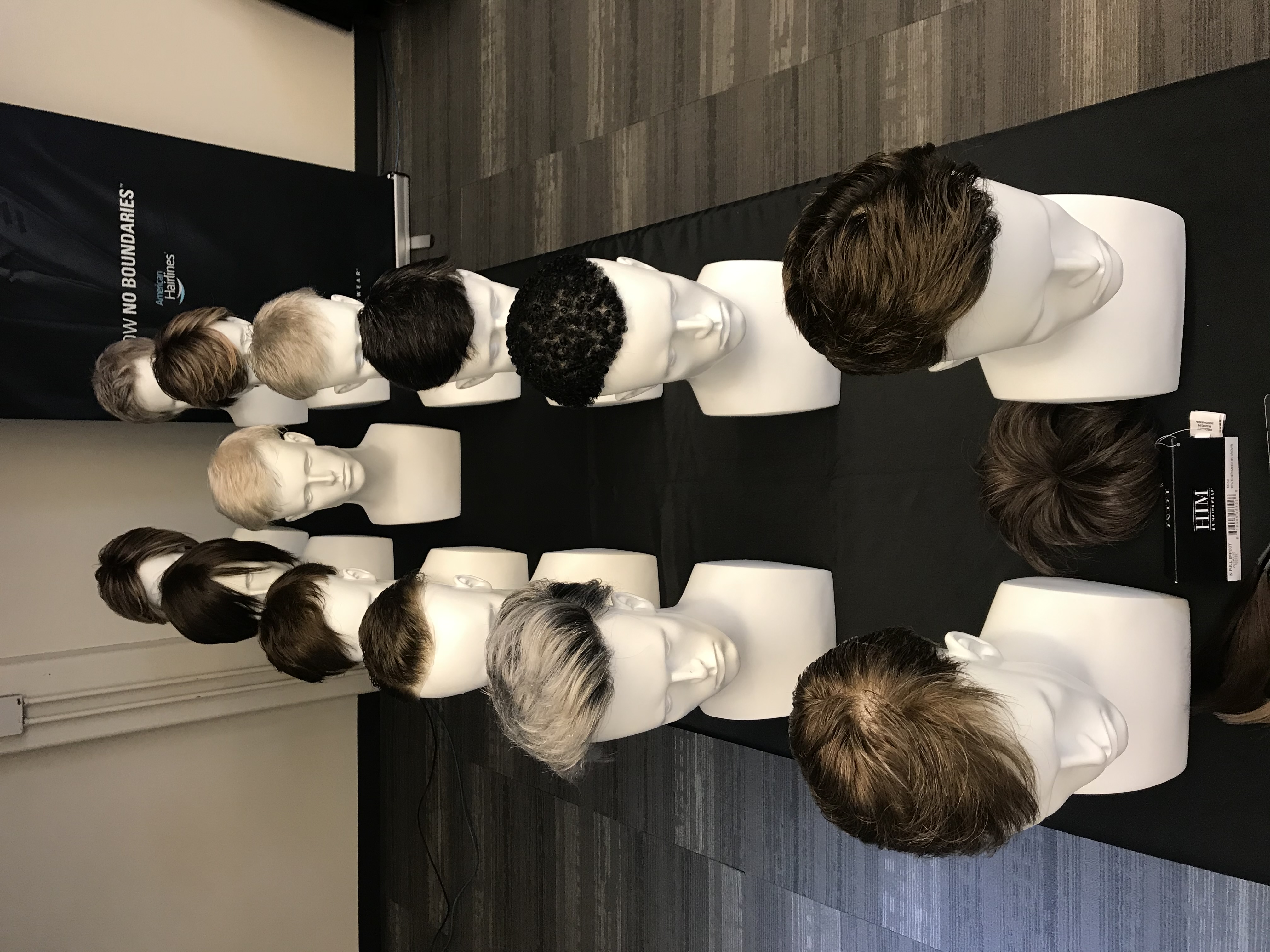 a row of mannequin heads with different hair styles
