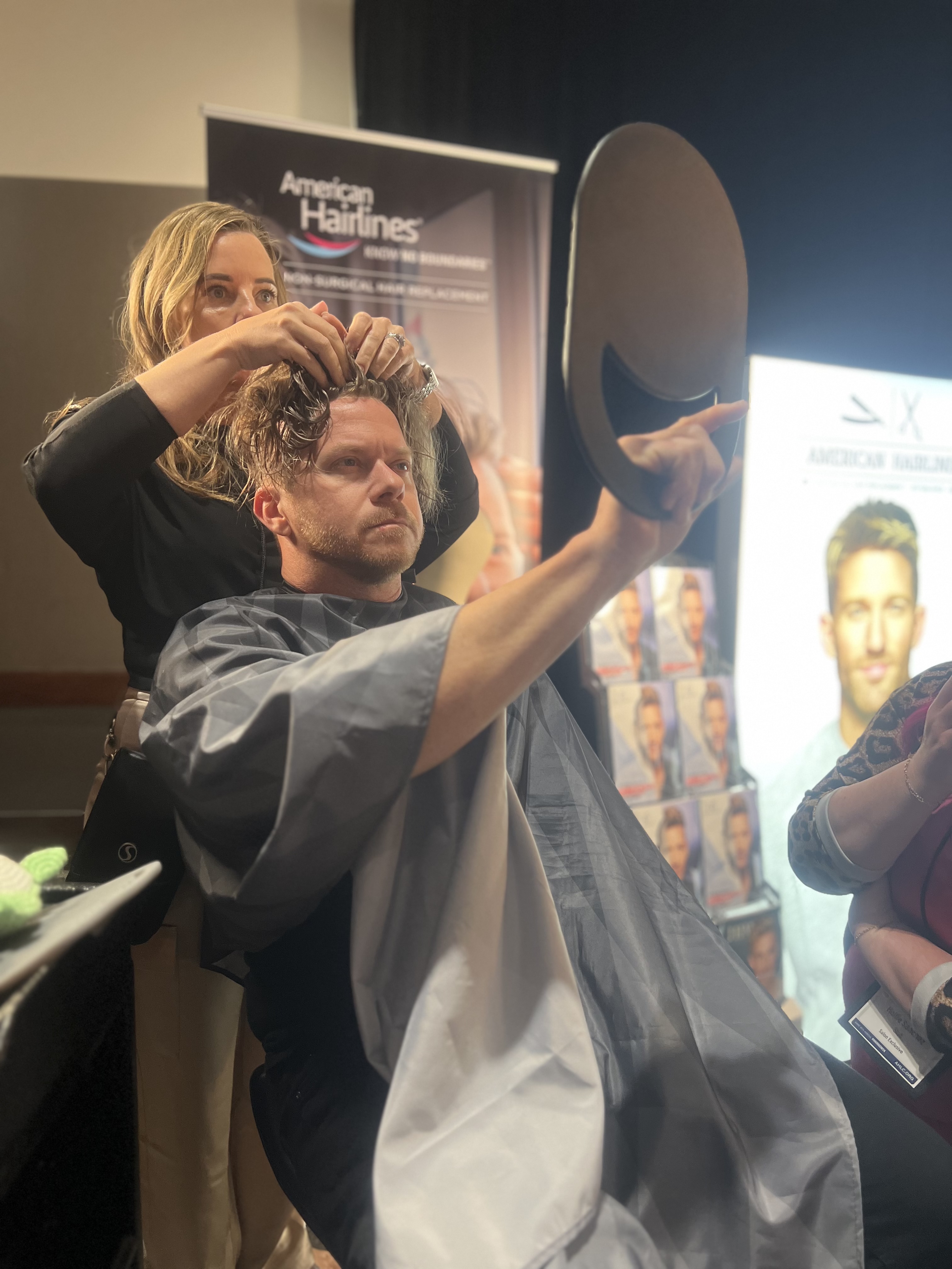 a woman cutting a man's hair