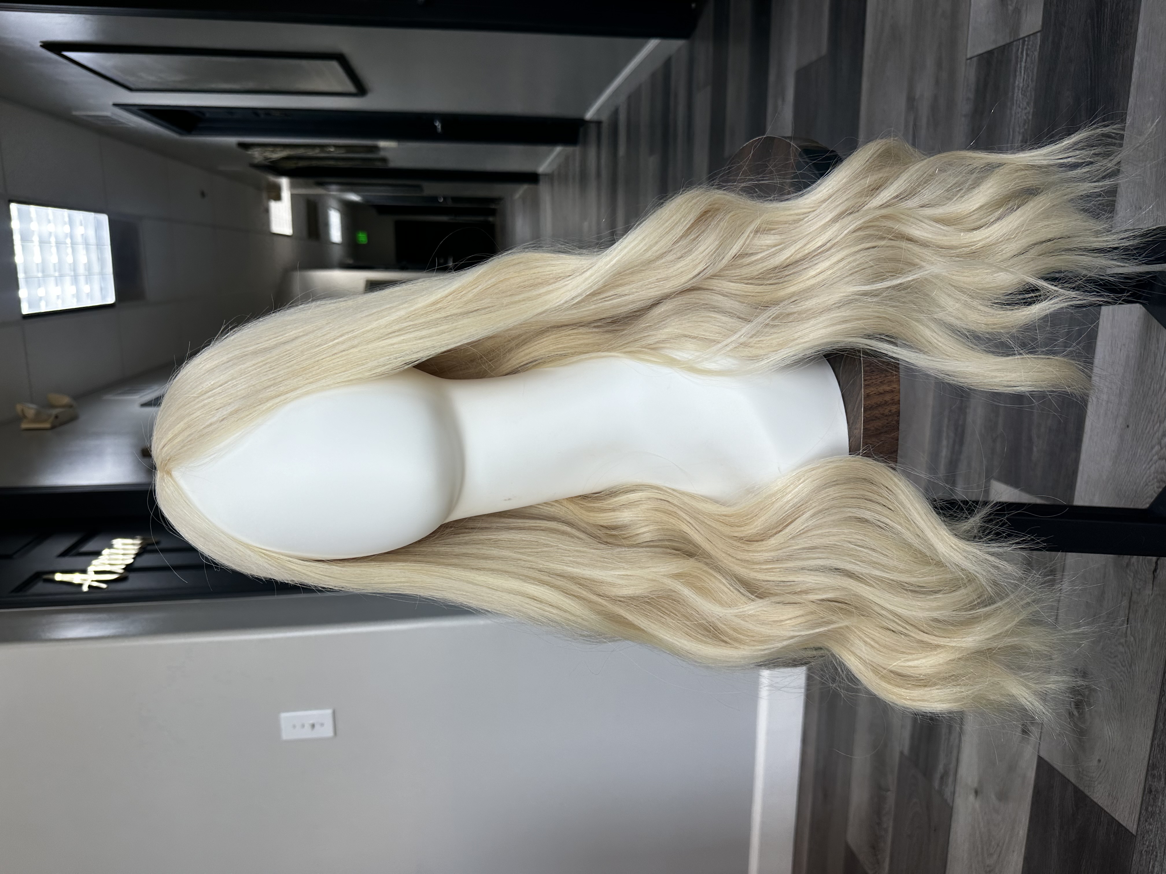 a mannequin head with long blonde hair